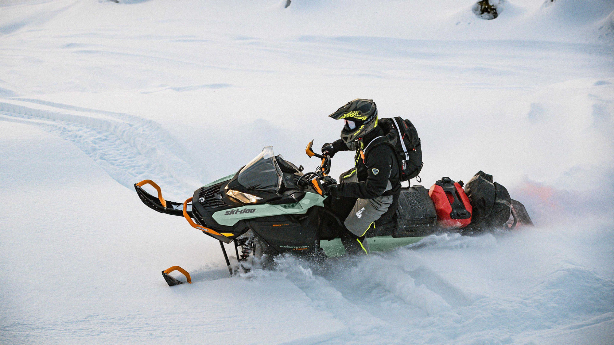 Men riding deep snow with a 2024 Ski-Doo Expedition