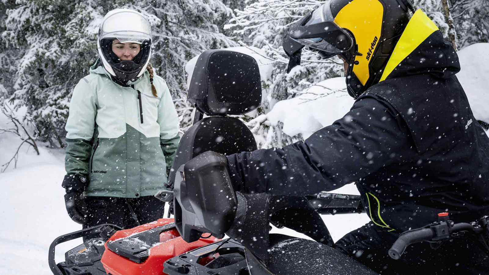 Man installing a LinQ 1+1 Seat on his Ski-Doo