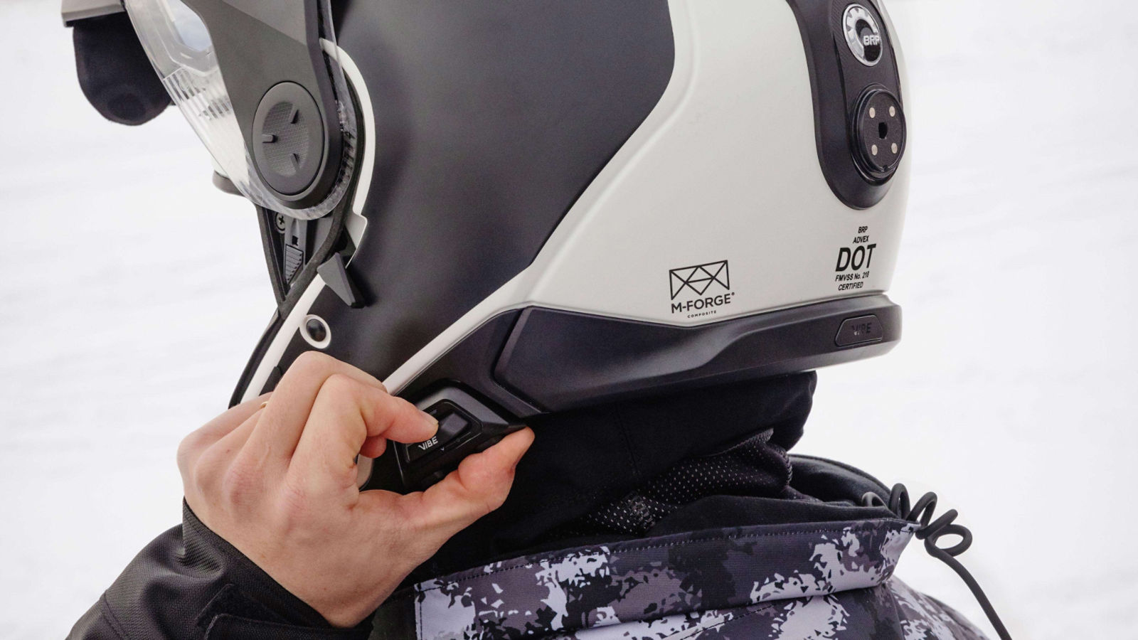 Man activating the Vibe Communiccation system on is Advex Helmet