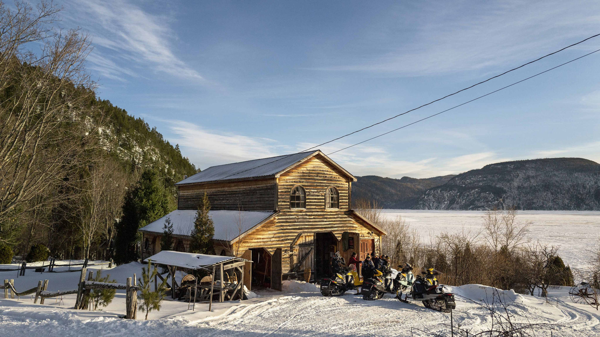 Group a snowmobile parked in front of a cabin