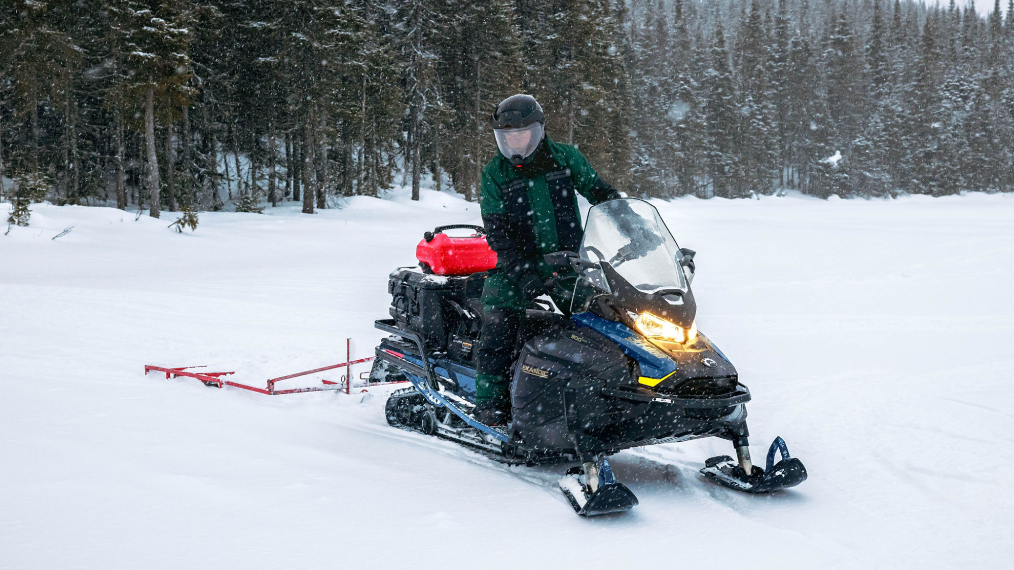 2025 Ski-Doo Skandic Utility Snowmobile pulling a sled