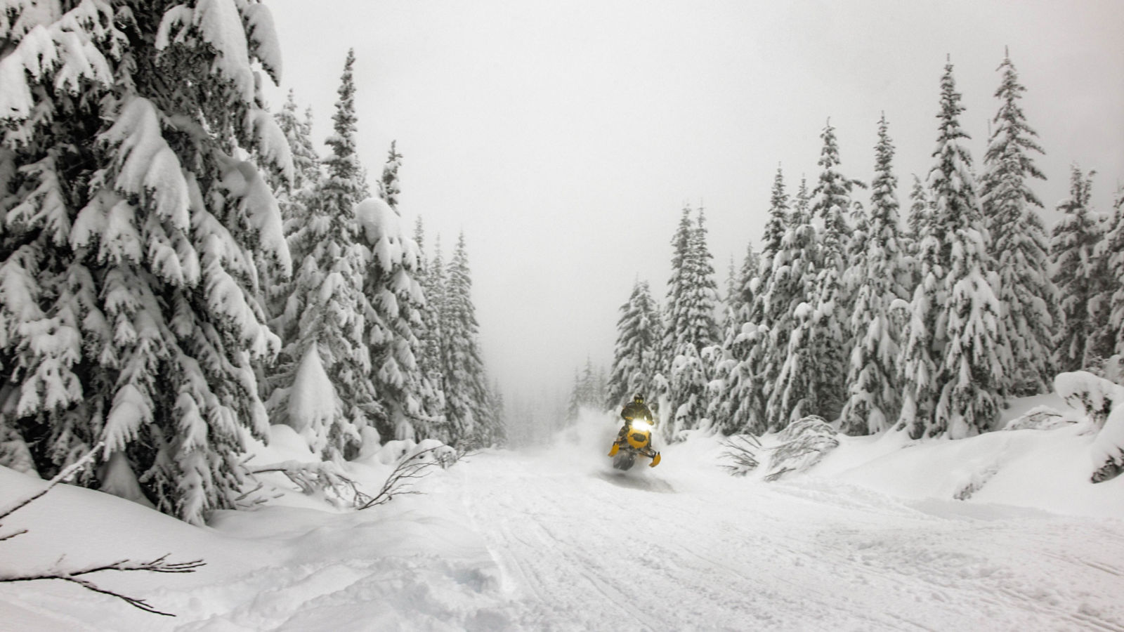 Rider performing a jump on a 2025 Ski-Doo MXZ trail snowmobile