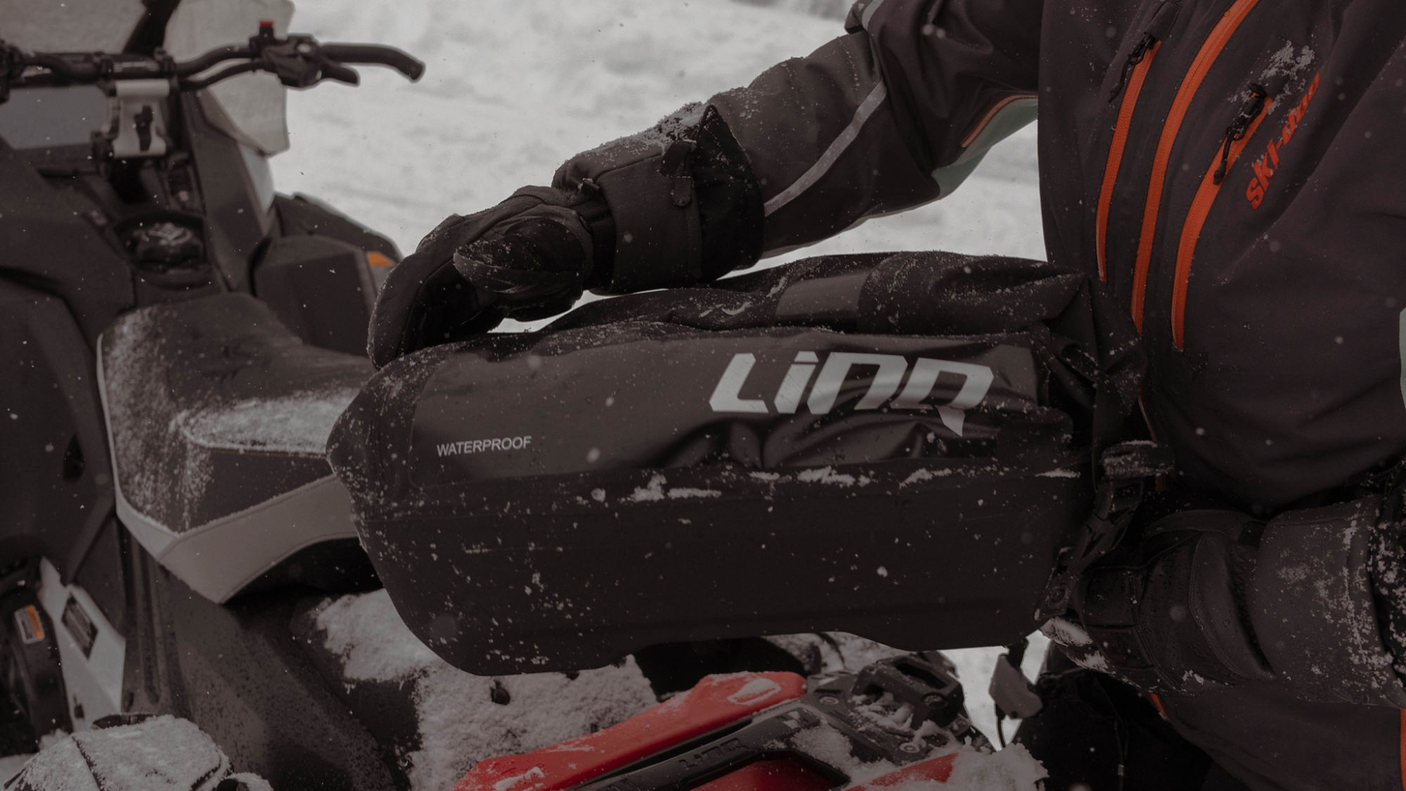 LinQ waterproof bag about to be installed on a 2025 Ski-Doo Renegade snowmobile
