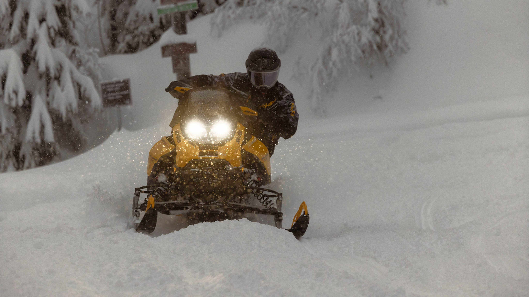 Rider taking a tight turn through snowy trails at high speed