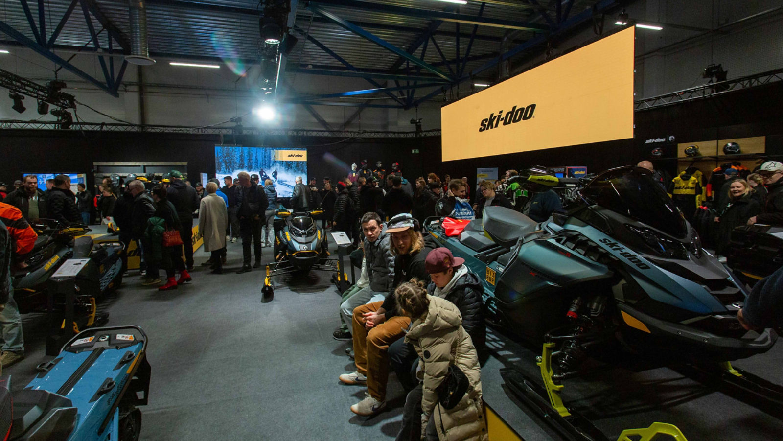 Visitors exploring the 2026 Ski-Doo snowmobiles at the snowmobile fair