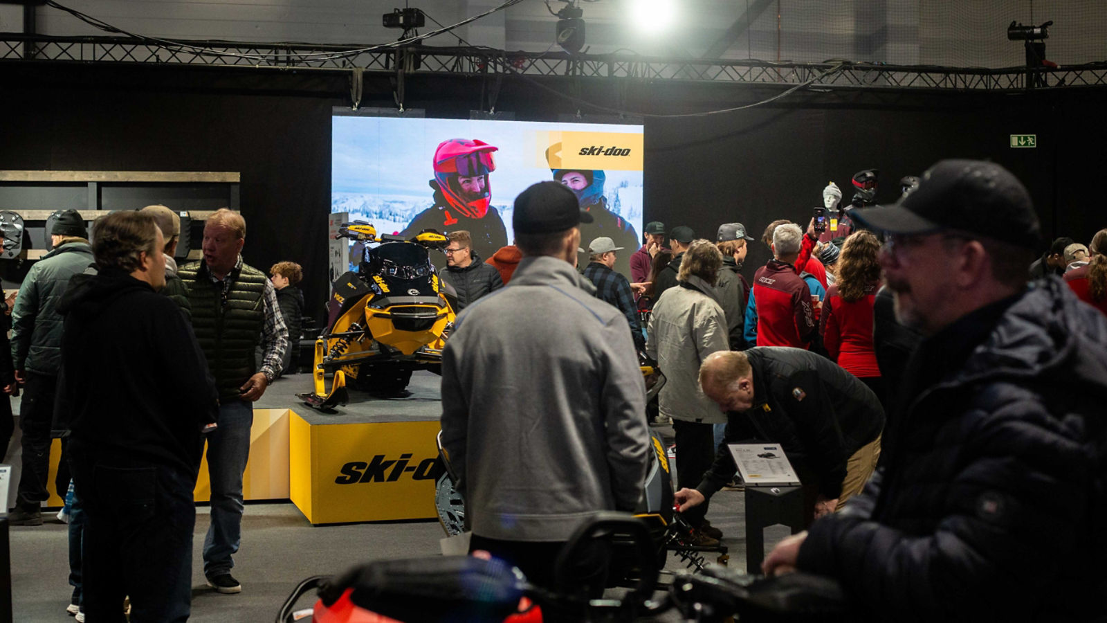 Visitors exploring the 2026 Ski-Doo snowmobiles at the snowmobile fair