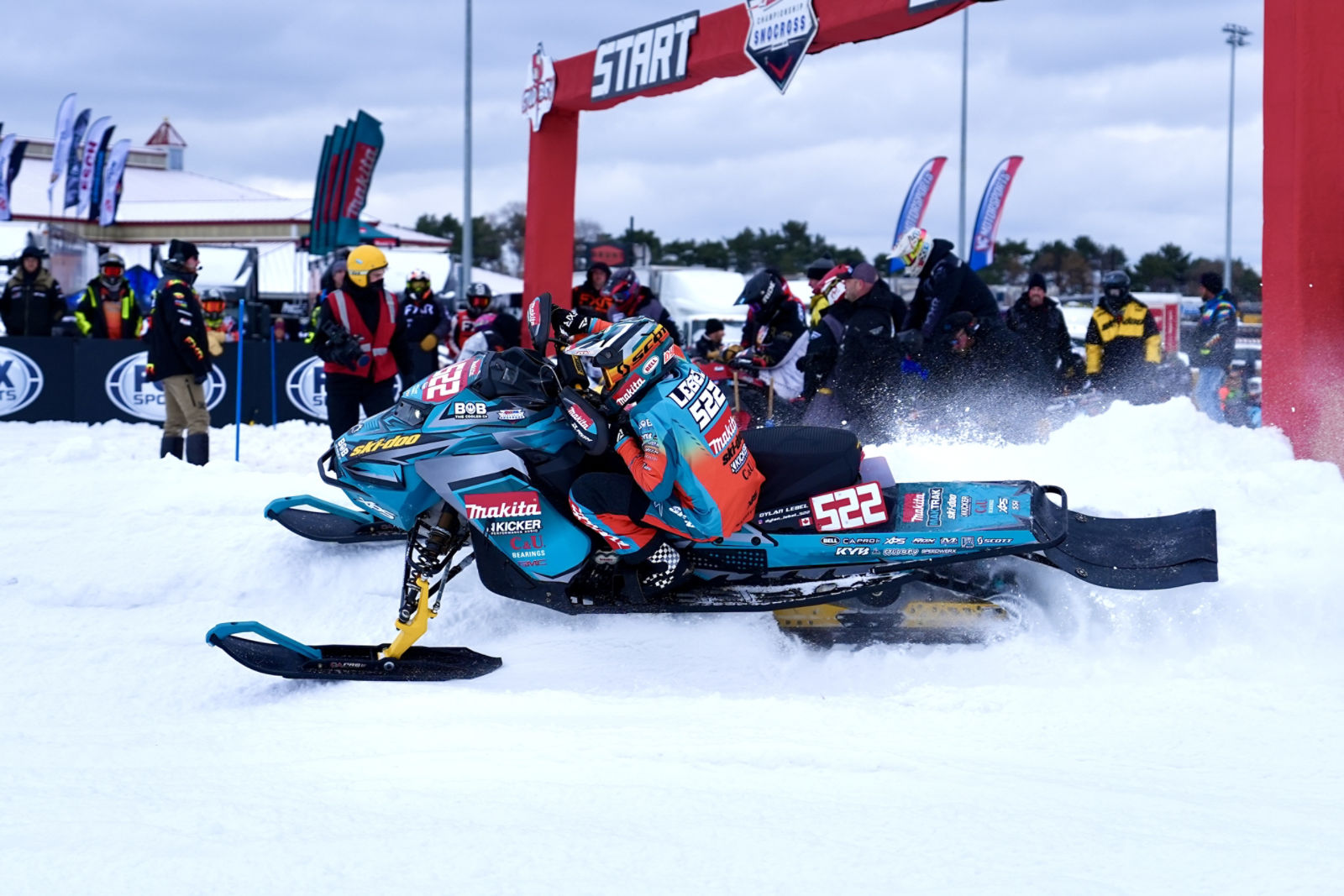 A Ski-Doo snowmobile at the starting line of a SnoCross race event