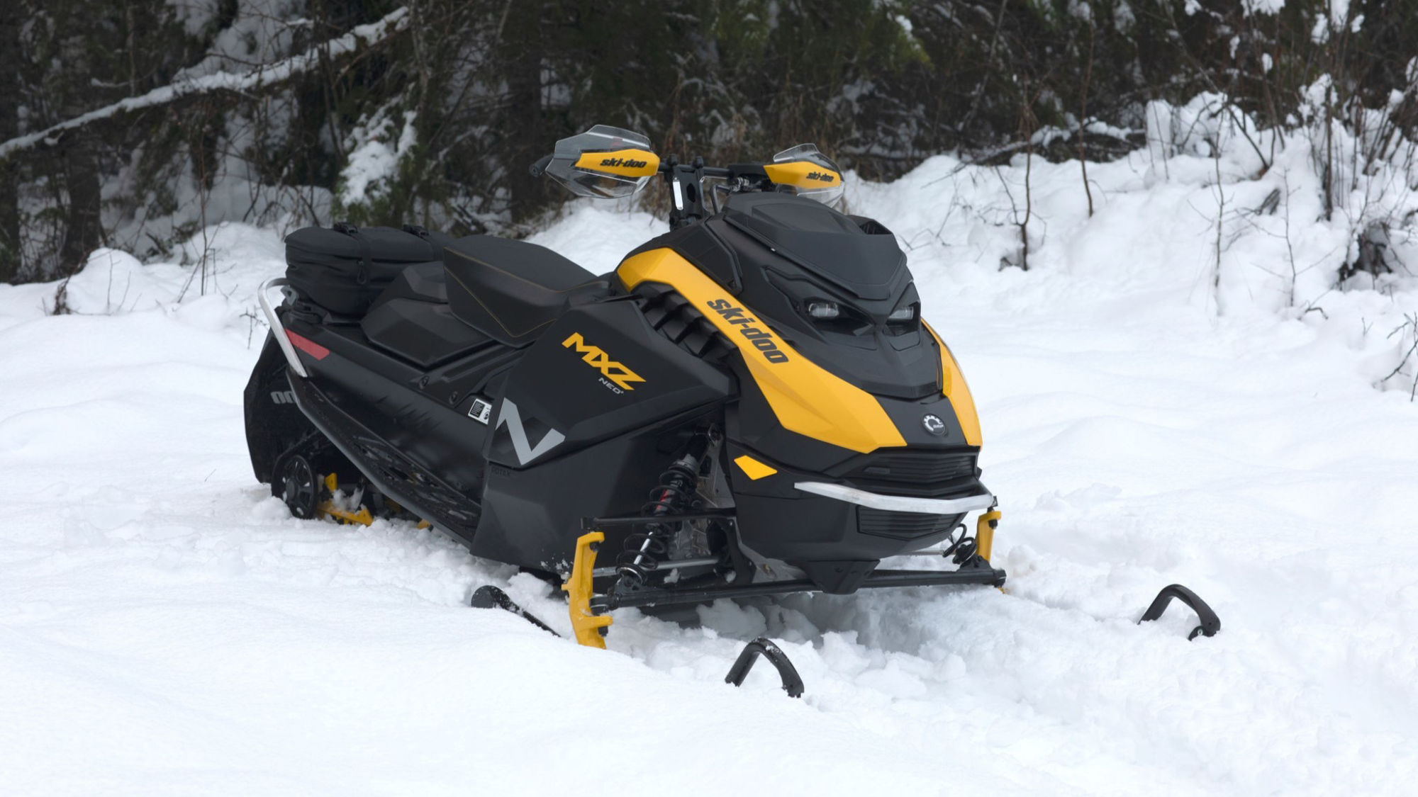 2026 Ski-Doo MXZ NEO+ in the middle of a snowy forest