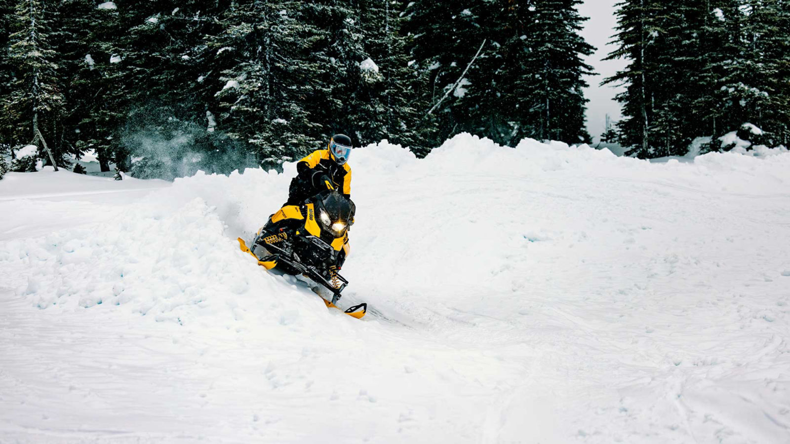 Person riding a 2027 Ski-Doo snowmobile in the snow