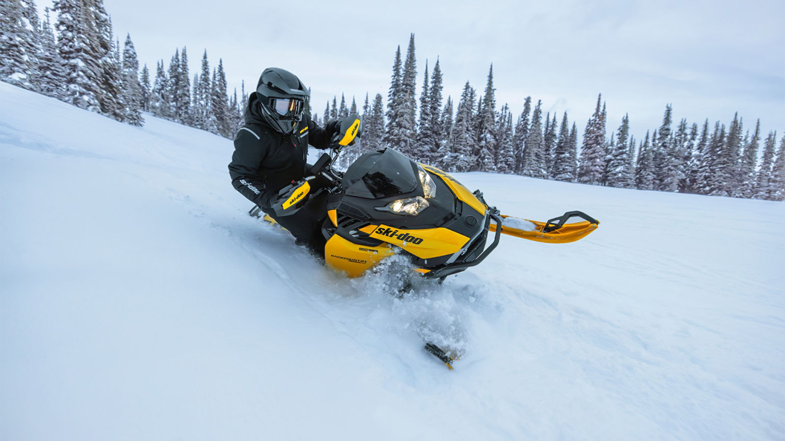 Rider riding down a snowy hill on a 2027 Ski-Doo Backcountry RS