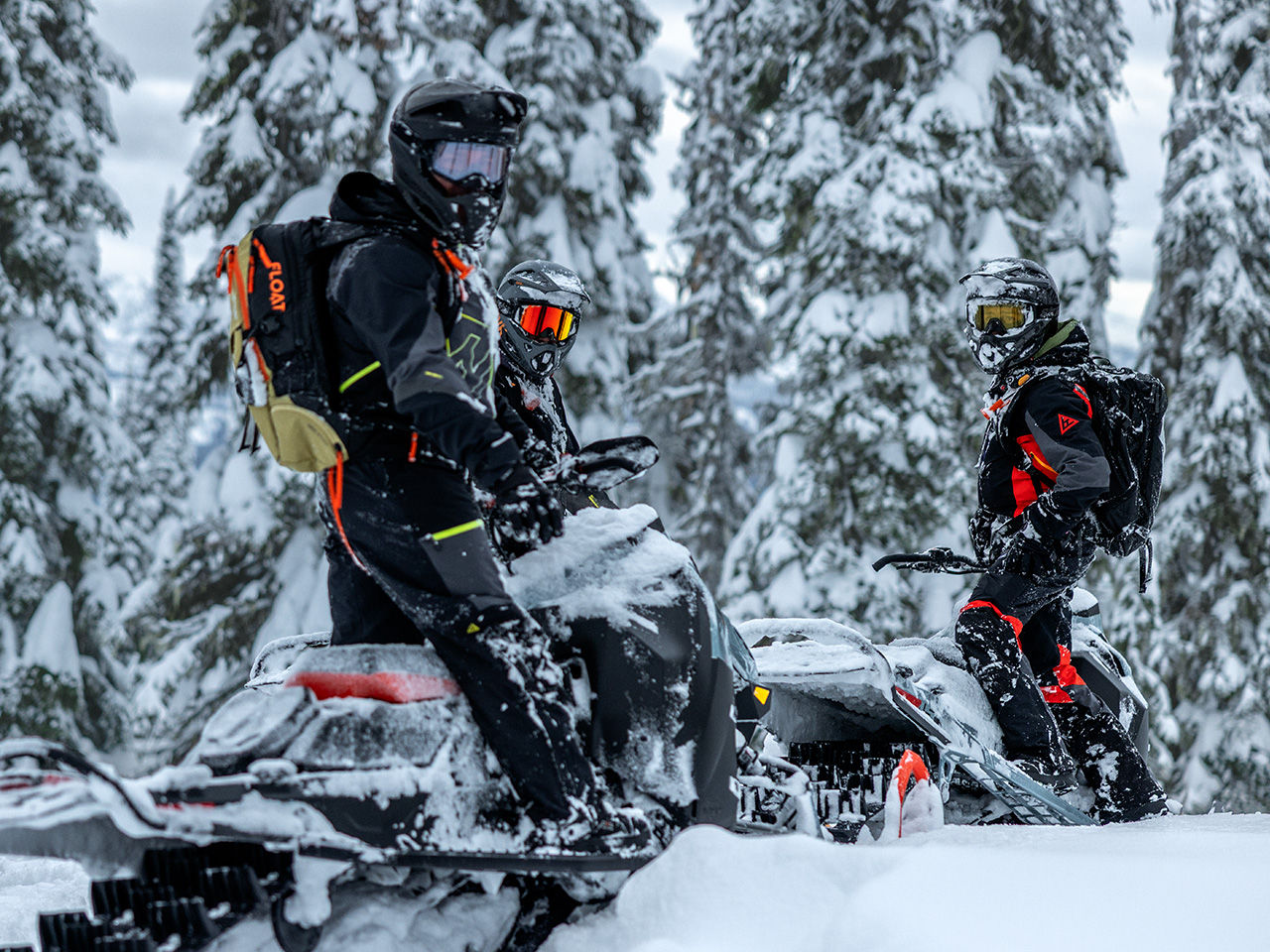 Snowmobile enthusiats wearing a riding safety helment and Ski-Doo branded goggles