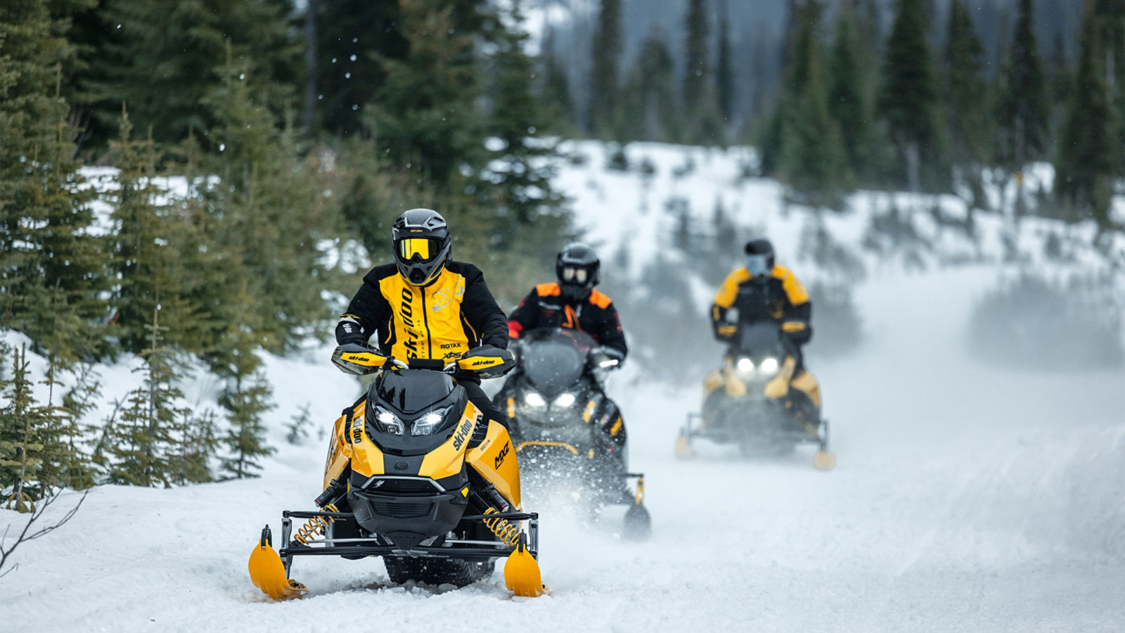 Three snowmobilers riding on their 2027 Ski-Doo snowmobiles