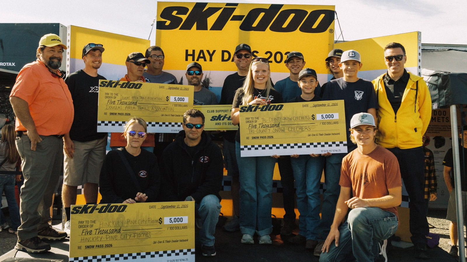 Group of snowmobile enthusiasts celebrating a successful Hay Days event