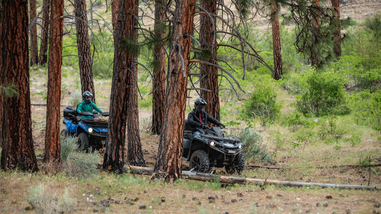 couple of can-AM riders in the forest