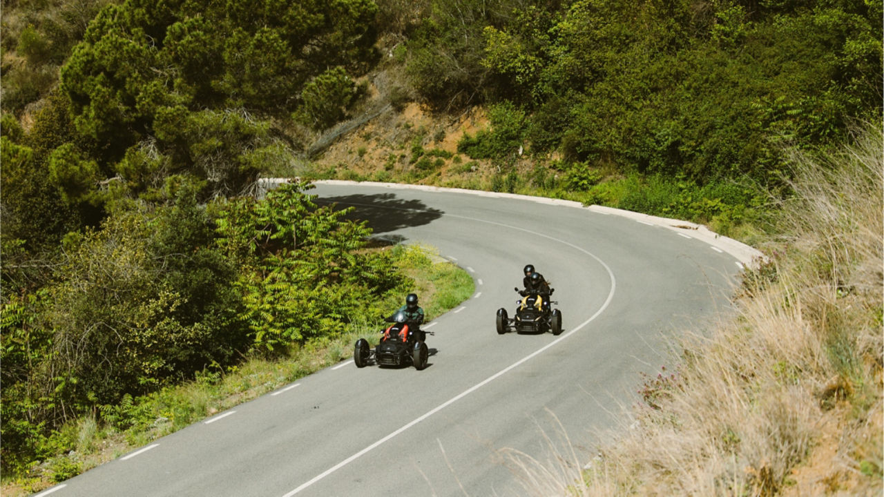 two riders going up a hill