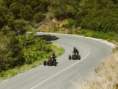 two riders going up a hill