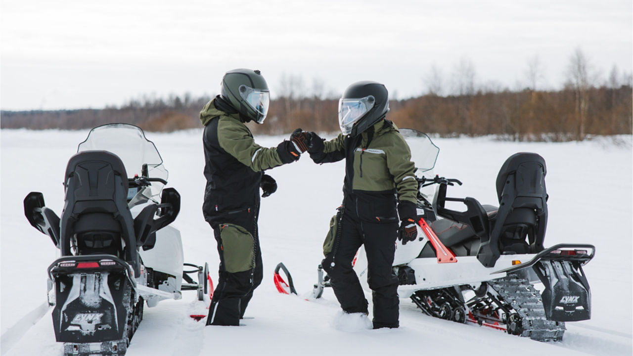 two riders fistbumping