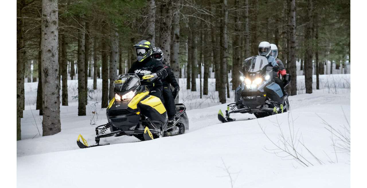 family ski doo ride in the forest