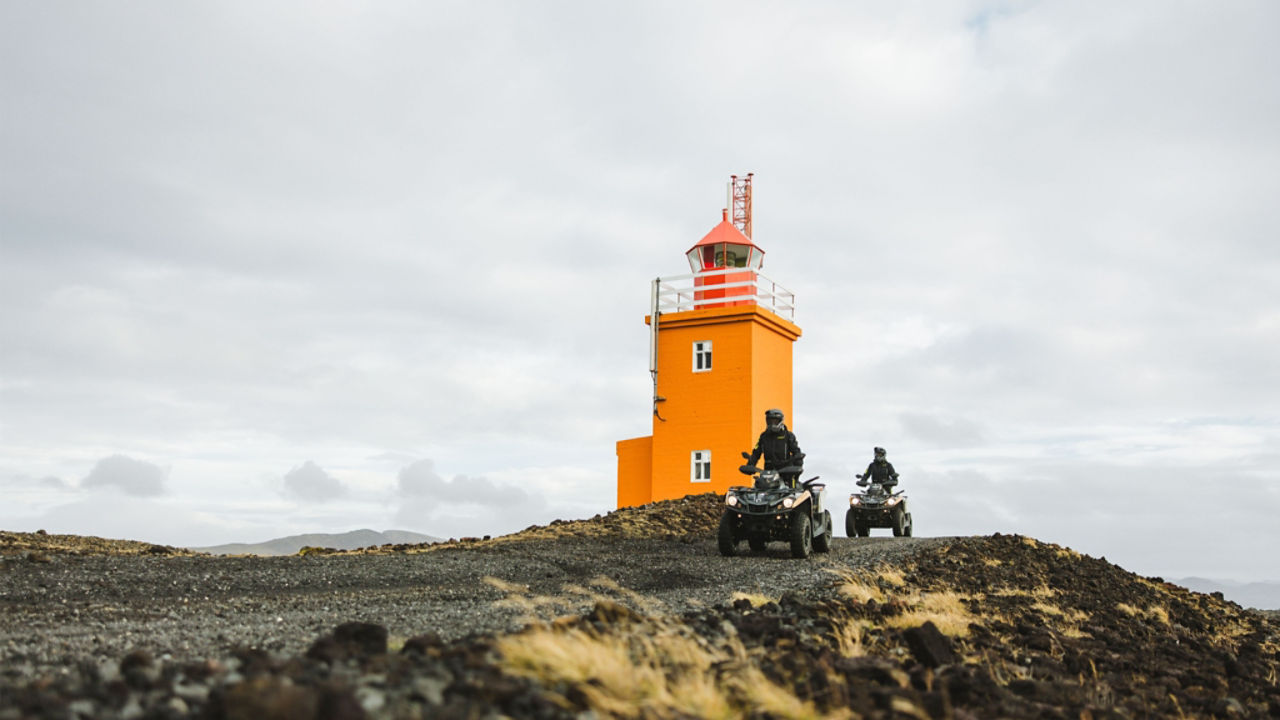 riding in front of a lighthouse