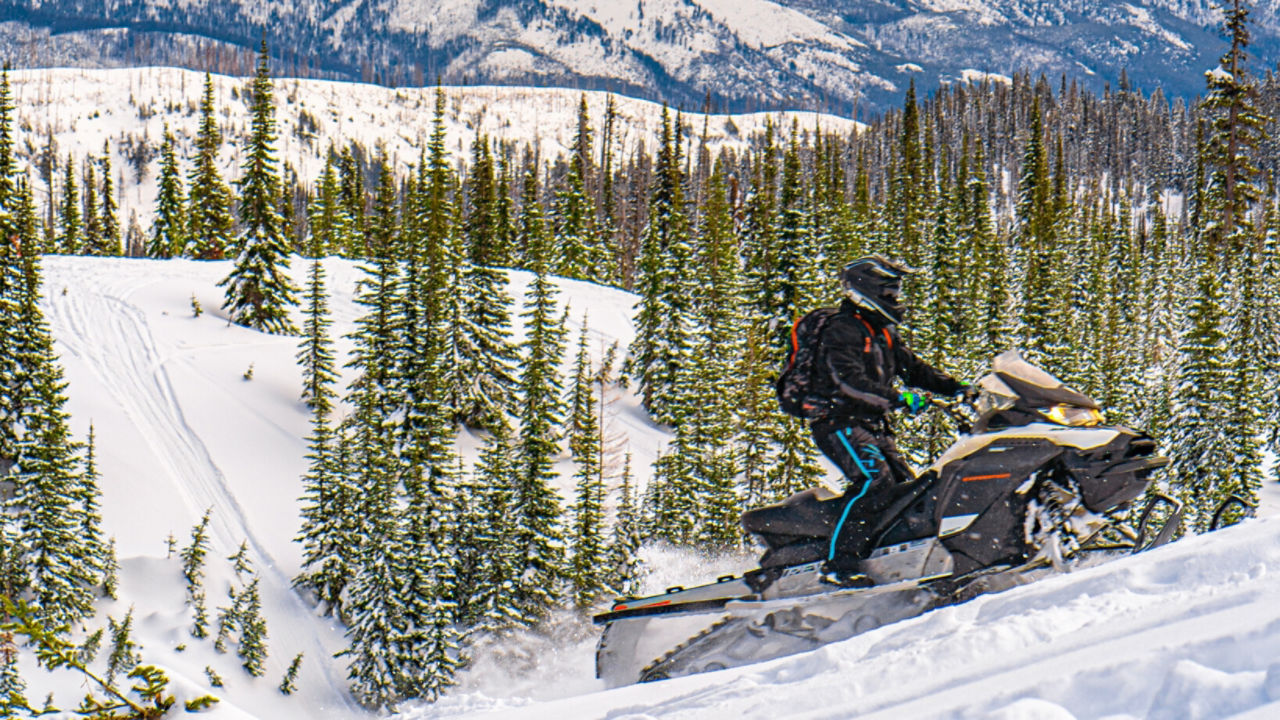 climbing a mountain on a Ski-Doo