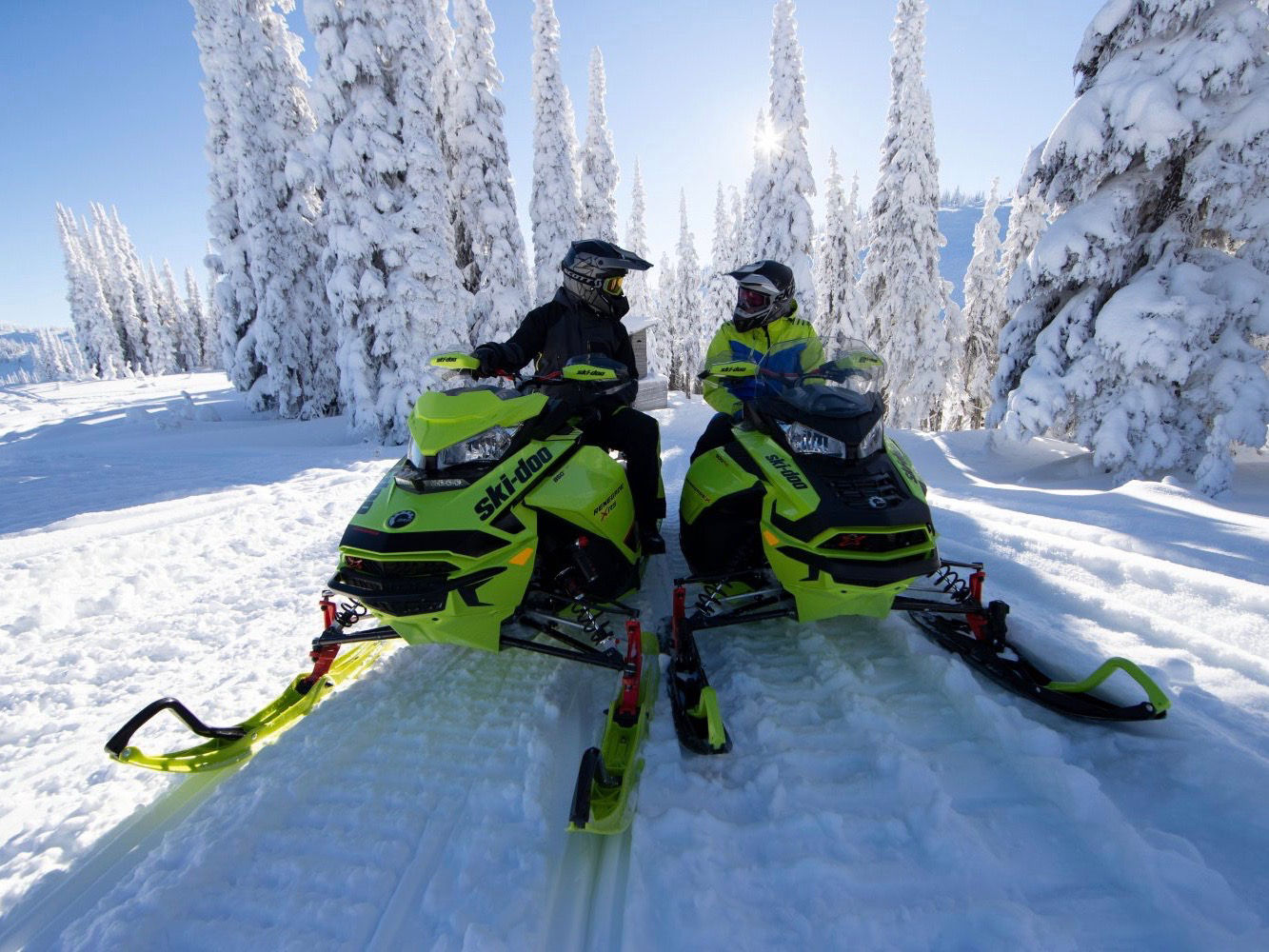 A snowmobilers talking on their Ski-Doo
