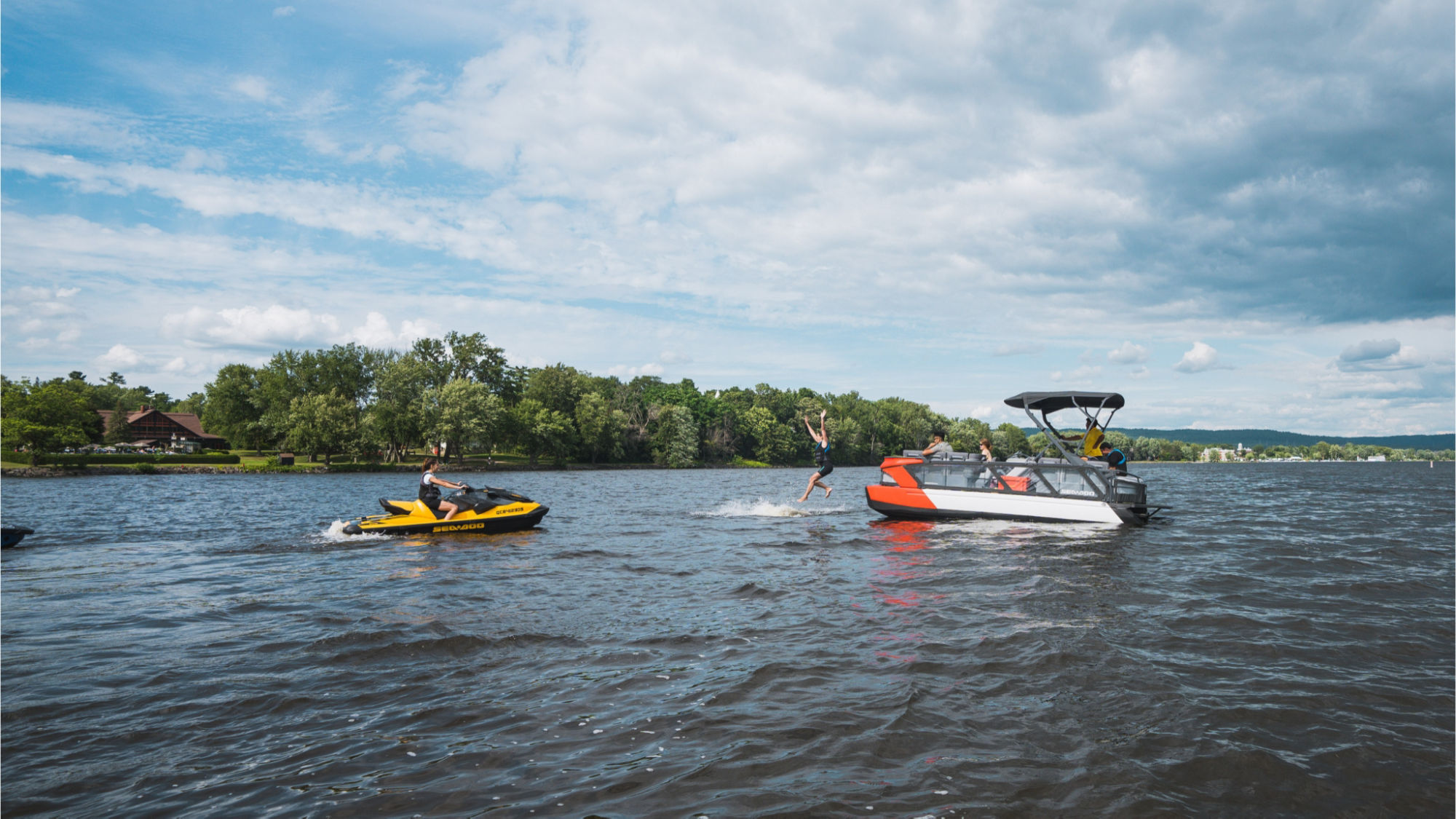 Sea-Doo personal watercraft and pontoon riding on the water